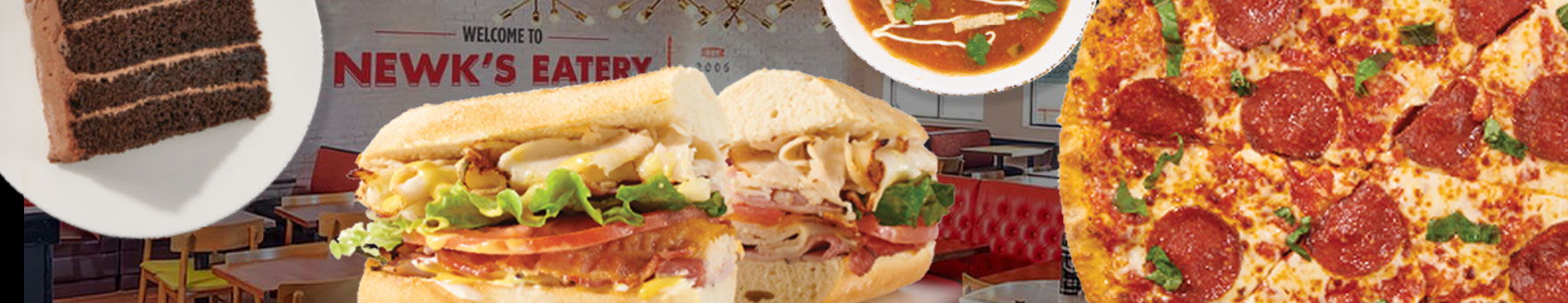 Fresh sandwiches are flanked on either side by pizza, chocolate cake, soup and other food items